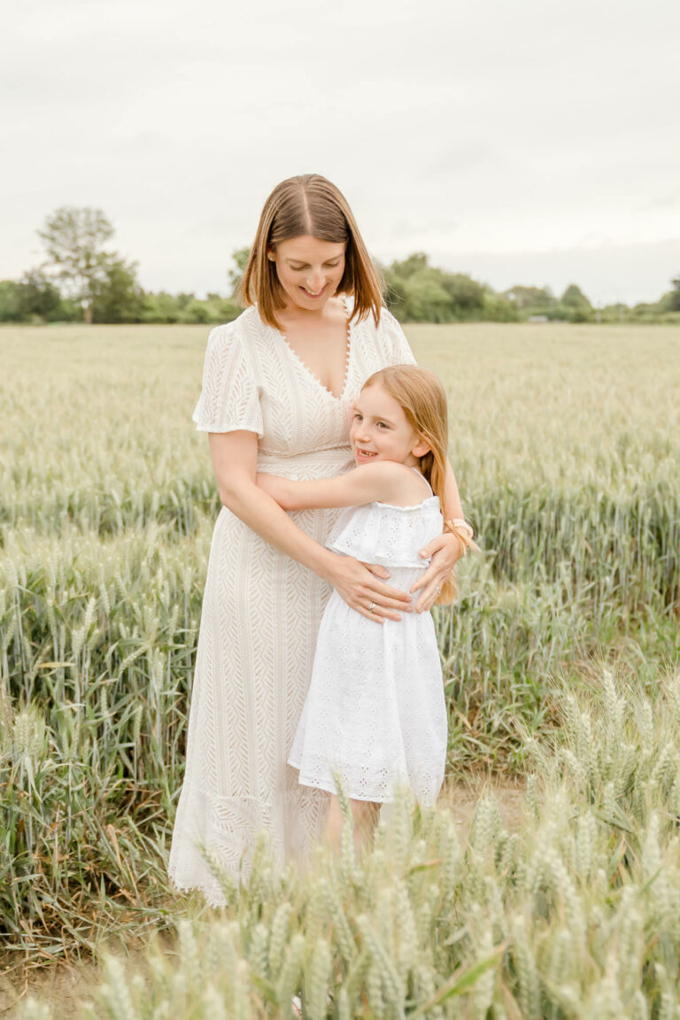Mother and daughter in a field at their family photoshoot in Colchester