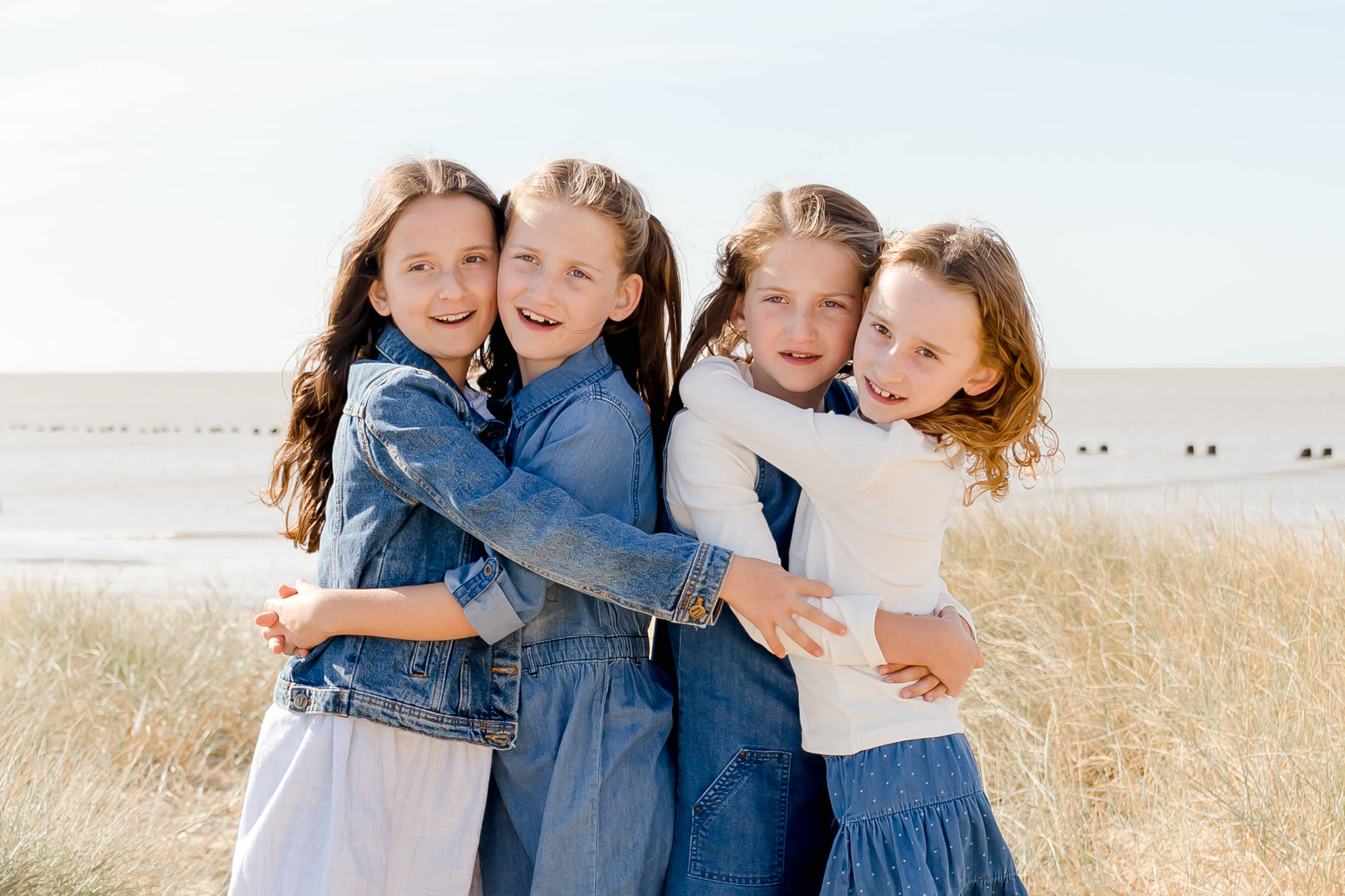 Children hugging at family photography session near Colchester