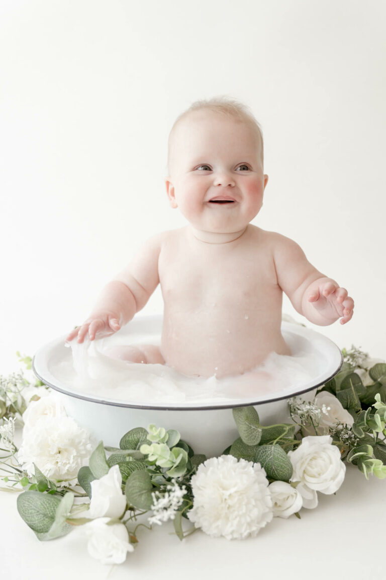 Baby girl in milk bath for sitter photoshoot in Colchester